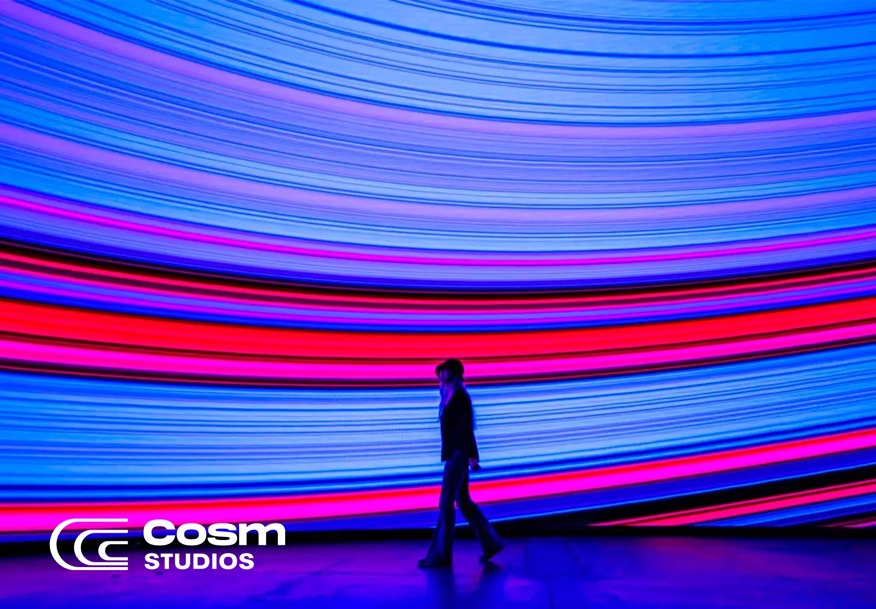 a guest stands in front of an abstract art experience at the SLC Experience Center